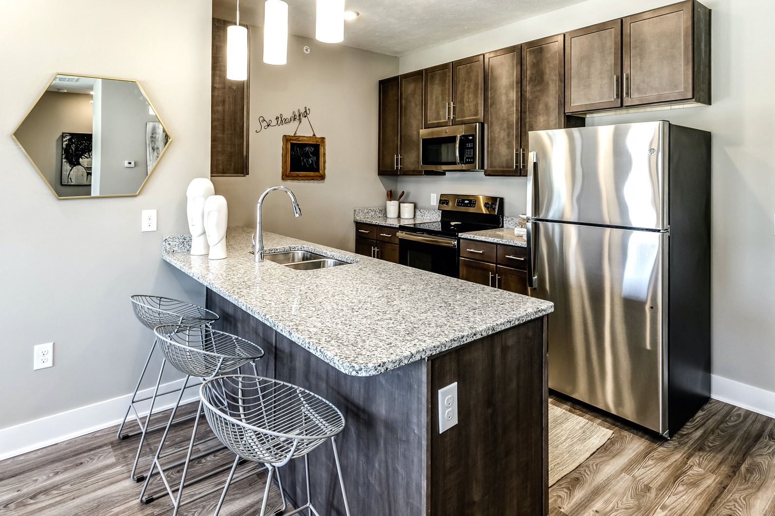 Espresso shaker cabinets kitchens with extra storage and stainless steel appliances at AXIS apartments in Papillion, NE